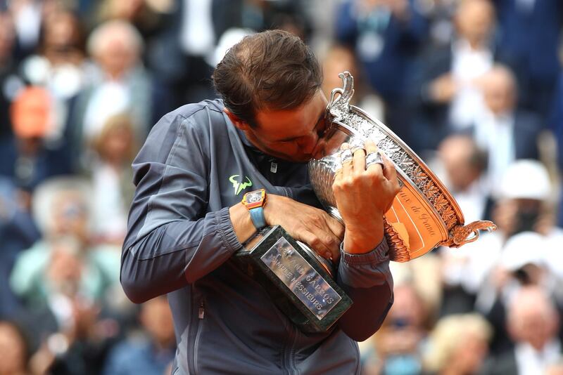 PARIS, FRANCE - JUNE 09: Rafael Nadal of Spain celebrates with the trophy following the mens singles final against Dominic Thiem of Austria during Day fifteen of the 2019 French Open at Roland Garros on June 09, 2019 in Paris, France. (Photo by Julian Finney/Getty Images)