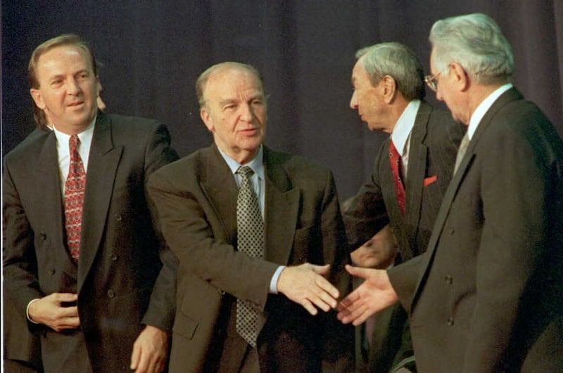 Federation of Bosnia-Herzegovina President Kresimir Zubak, left, looks on as Bosnian President Alija Izetbegovic, second left, and Republic of Croatia President Franjo Tudjman, right, shake hands on November 10, 1995. Bosnia and Croatia signed an agreement toward reconciliation in the former Yugoslavia. AFP