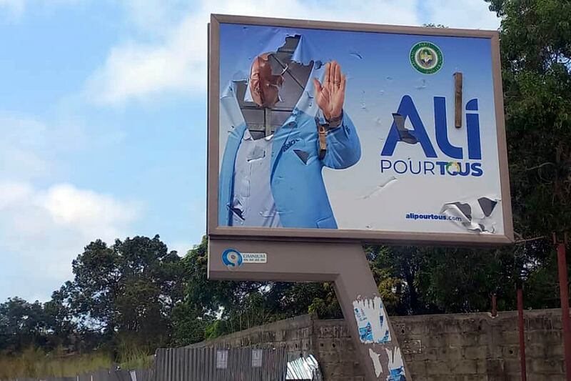 A defaced billboard of Gabon President Ali Bongo on an empty street in Libreville. AP