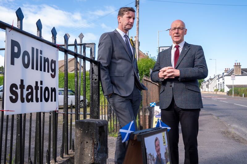 Scottish First Minister and SNP leader John Swinney, right, after casting his vote in Burrelton, Perthshire. PA
