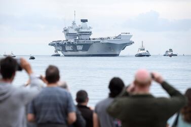 Members of the public gather for the arrival of the HMS Queen Elizabeth supercarrier as it heads into port on August 16, 2017 in Portsmouth, England. The HMS Queen Elizabeth is the lead ship in the new Queen Elizabeth class of supercarriers. Weighing in at 65,000 tonnes, she is the largest warship deployed by the British Royal Navy. Leon Neal/Getty Images