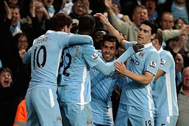 Carlos Tevez celebrates with his teammates after Samir Nasri (hidden) scored against Chelsea.