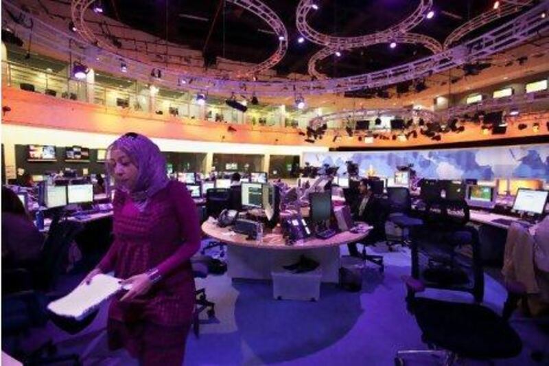 Hopes are now high in Doha that its acclaimed coverage of the Arab Awakening will finally win over the US cable companies it has been wooing for five years. Above, the newsroom of Al Jazeera English.