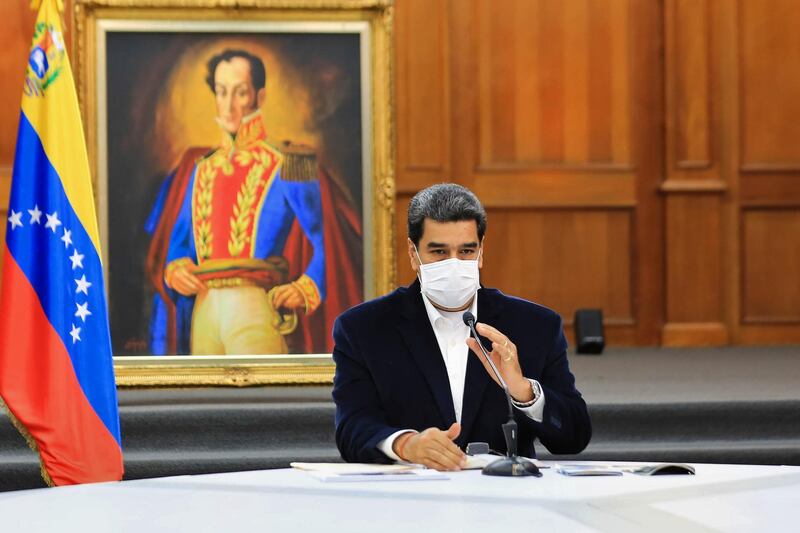Handout picture released by the Venezuelan Presidency showing Venezuela's President Nicolas Maduro wearing a face mask as a preventive measure against the novel coronavirus, COVID-19, during a meeting with members of the Bolivarian National Armed Forces (FANB), at Miraflores Presidential Palace in Caracas on May 4, 2020. Venezuela's Attorney General Tarek William Saab on Monday accused opposition leader Juan Guaido of contracting "mercenaries" to lead an "invasion" that the Nicolas Maduro regime claims to have thwarted. The government had said Sunday that it foiled an attack from the sea aimed at toppling the socialist president, killing eight assailants and capturing two others. - RESTRICTED TO EDITORIAL USE - MANDATORY CREDIT "AFP PHOTO / VENEZUELA'S PRESIDENCY / JHONN ZERPA" - NO MARKETING - NO ADVERTISING CAMPAIGNS - DISTRIBUTED AS A SERVICE TO CLIENTS
 / AFP / Venezuelan Presidency / Jhonn ZERPA / RESTRICTED TO EDITORIAL USE - MANDATORY CREDIT "AFP PHOTO / VENEZUELA'S PRESIDENCY / JHONN ZERPA" - NO MARKETING - NO ADVERTISING CAMPAIGNS - DISTRIBUTED AS A SERVICE TO CLIENTS
