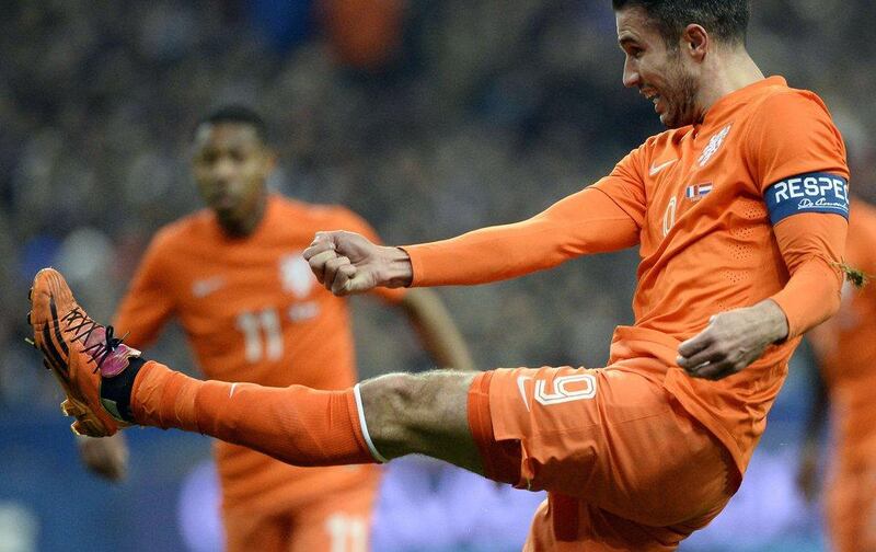 Robin van Persie and Netherlands lost to France 2-0. They'll play in Group B at the 2014 World Cup with Spain, Chile and Australia. Franck Fife / AFP