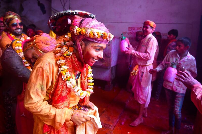 Hindu devotees celebrate Holi, the spring festival of colours, during a traditional gathering at a temple in Nandgaon village in Uttar Pradesh state on March 5, 2020. Holi is observed in India at the end of the winter season on the last full moon of the lunar month. AFP