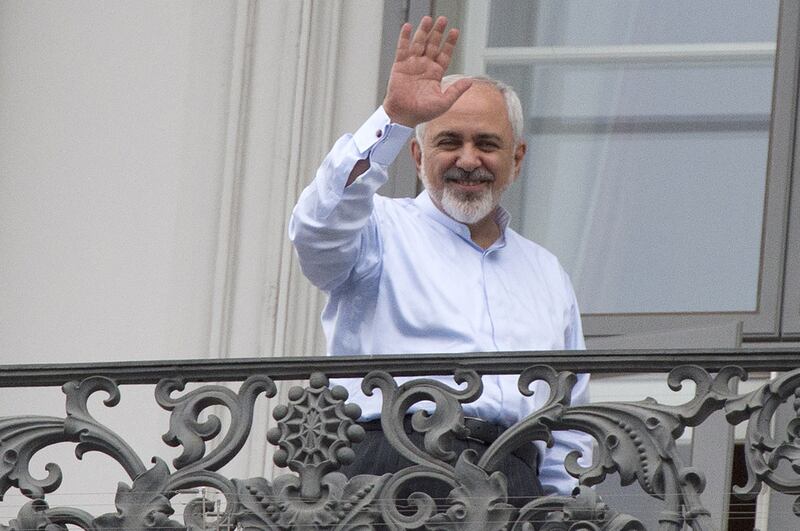 Iranian Foreign Minister Mohammad Javad Zarif waves from a balcony of the Palais Coburg Hotel where a historic agreement over Iran's nuclear programme is expected to be announced on Tuesday. AFP PHOTO/JOE KLAMAR


