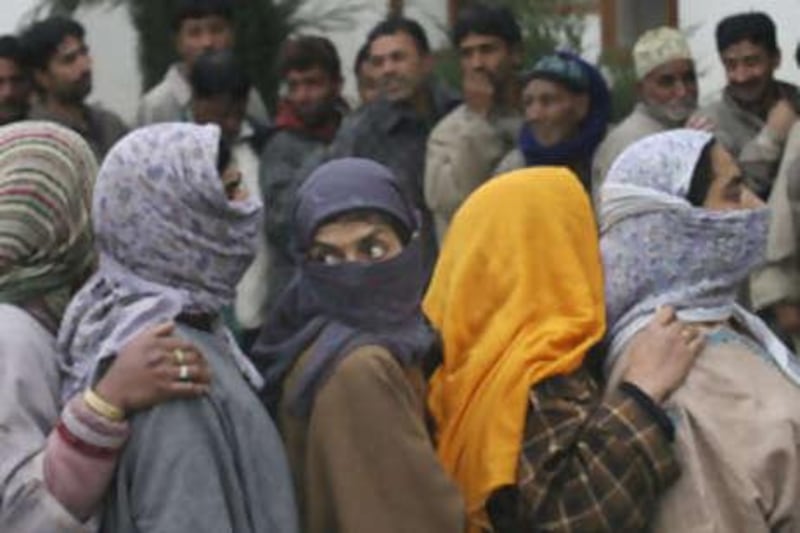 Kashmiri Muslims stands in a queue to cast their vote outside a polling station in Srinagar.