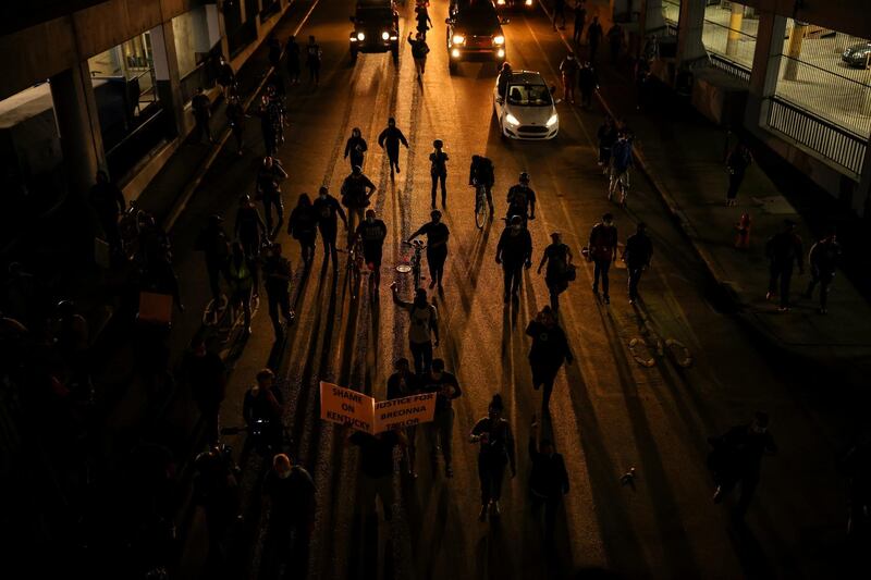Protesters march as they enter a tunnel a day after a grand jury considering the March killing of Breonna Taylor, a Black medical worker, in her home in Louisville, Kentucky. Reuters
