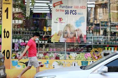 A store in Bur Dubai displays an offer on face masks. Officials have taken steps to drive down infections across the UAE. Chris Whiteoak / The National