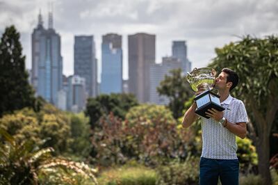 epa08189627 Novak Djokovic of Serbia poses for photos with the Norman Brookes Challenge Cup the day after winning the Men's Singles Final at the Australian Open grand slam tennis tournament, in Melbourne, Australia, 03 February 2020.  EPA/ROMAN PILIPEY