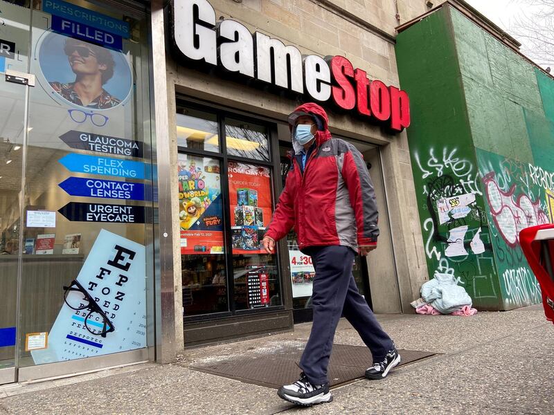 FILE PHOTO: A man walks in front of a GameStop store in the Jackson Heights neighborhood of New York City, New York, U.S. January 27, 2021. Picture taken January 27, 2021. REUTERS/Nick Zieminski/File Photo