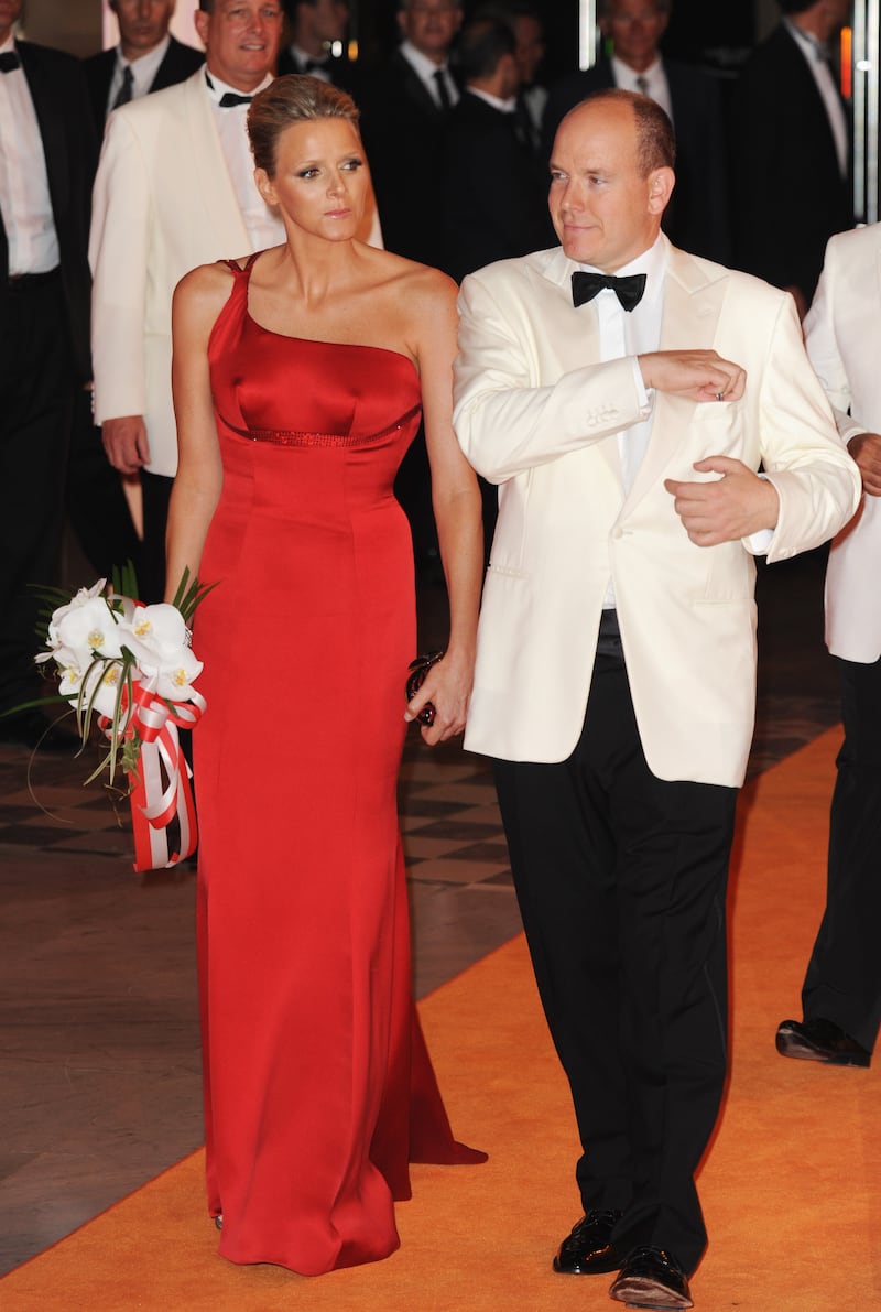Charlene Wittstock, in a red one-shouldered gown, and Prince Albert II of Monaco attend the 61st Monaco Red Cross Ball on July 31, 2009. Getty Images