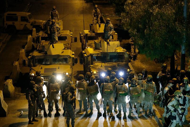 Lebanese soldiers prepare to move protesters from streets, during a protest against deteriorating living conditions and strict coronavirus lockdown measures, in Tripoli, Lebanon, Friday, Jan. 29, 2021. AP