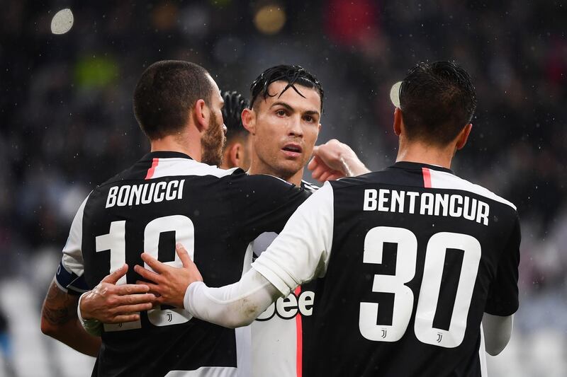 Juventus defender Leonardo Bonucci (L) celebrates with his teammate Cristiano Ronaldo (C) after scoring. AFP