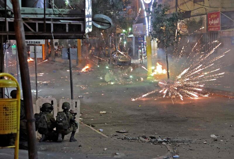 Palestinians clash with Israeli security forces in the city centre of the West Bank town of Hebron. AFP