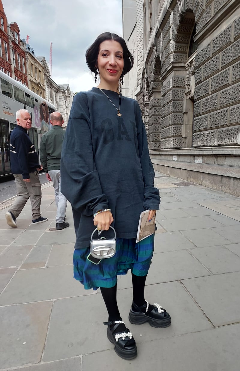 A woman in tones of dark grey with a quirky pair of shoes.