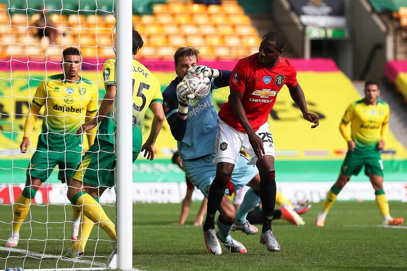 Norwich goalkeeper Tim Krul makes a save under pressure from United's Odion Ighalo. EPA