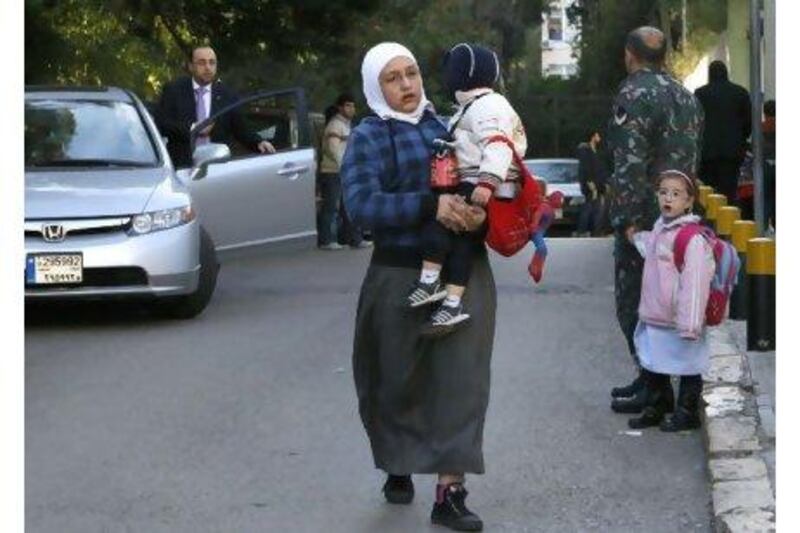 Children were taken home early from schools in Beirut yesterday after gatherings of black-clad men in the morning raised fears of violence.