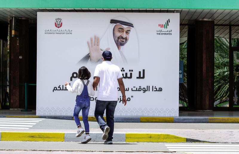 Abu Dhabi, United Arab Emirates, April 24, 2020.    
 A father and his daughter cross the street to get to the Abu Dhabi Central Bus Terminal during the first morning of Ramadan.
Section:  NA
For:  Standalone/Stock Images