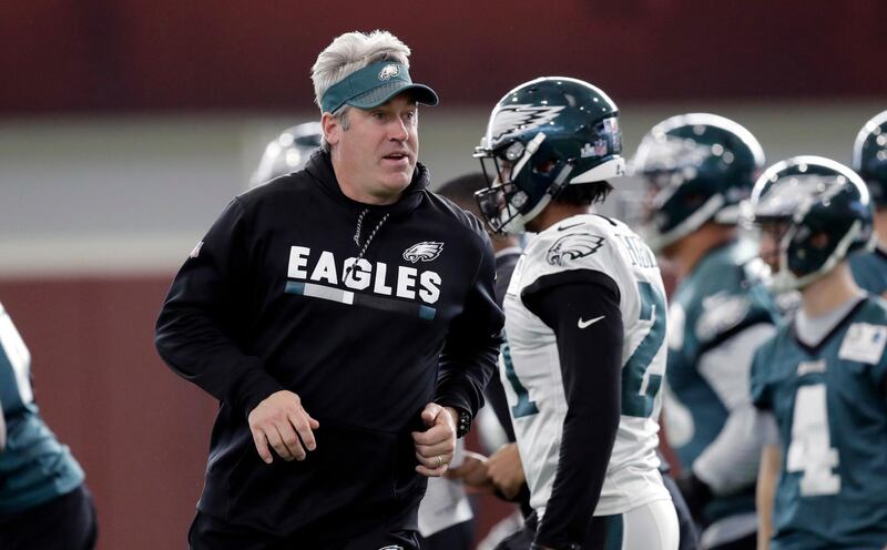 Philadelphia Eagles head coach Doug Pederson runs past players during a practice for the NFL Super Bowl 52 football game Thursday, Feb. 1, 2018, in Minneapolis. Philadelphia is scheduled to face the New England Patriots Sunday. (AP Photo/Eric Gay)