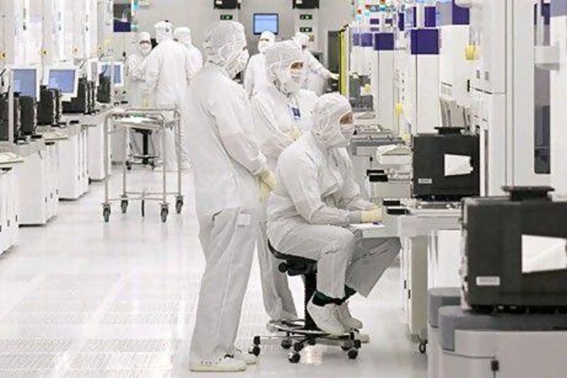Atic accounted for 40 per cent of Mubadala's revenues. Above, engineers work in one of several clean rooms at Globalfoundries in Dresden, Germany.