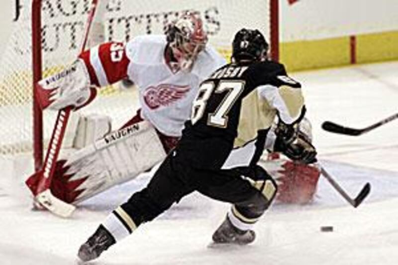 Crosby fires a shot past the Red Wings goaltender Howard.