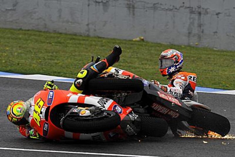 Valentino Rossi, left, and Casey Stoner collide in Jerez during the Spanish MotoGP.