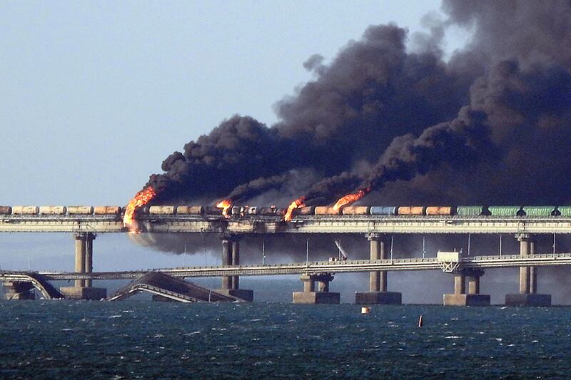 Black smoke billows from the Kerch bridge that links Crimea to Russia after a lorry exploded on October 8. AFP