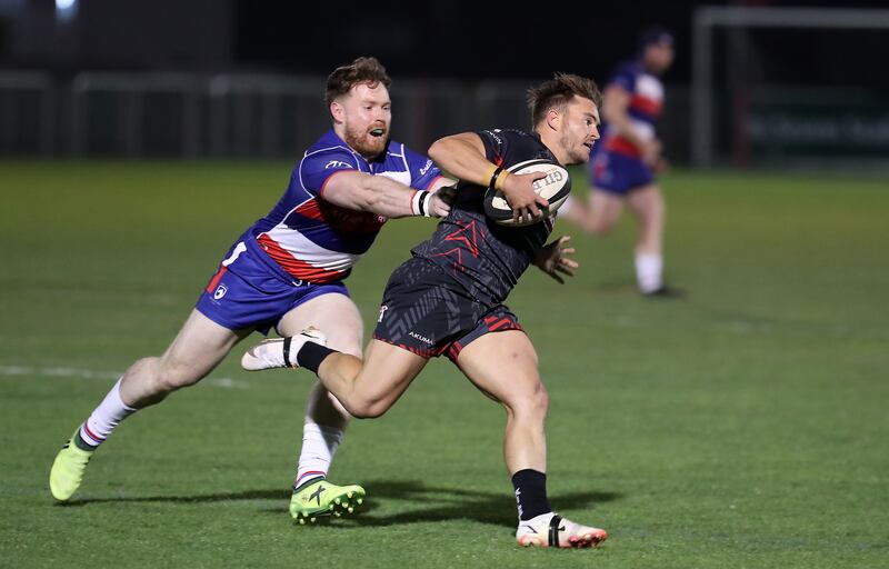 Conor Kennedy, right, of Dubai Exiles in action against Jebel Ali Dragons in the UAE Premierhsip semi-final play-off at The Sevens in Dubai on Friday, March 4, 2022. Pawan Singh / The National   