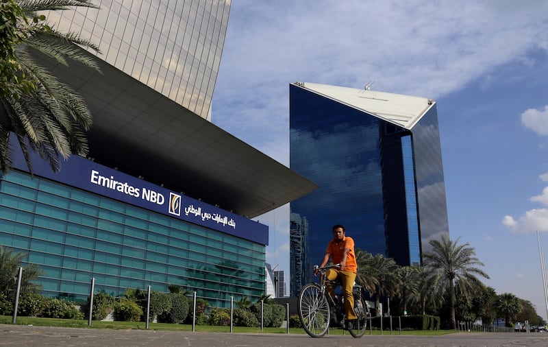 FILE PHOTO: A man rides a bicycle past Emirates NBD head office in Dubai, UAE January 30, 2018.  REUTERS / Satish Kumar / File Photo