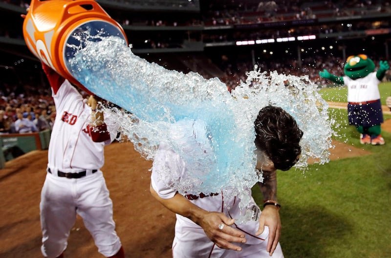 Boston Red Sox's Blake Swihart is doused with sports drink after his walk-off RBI double during the 13th inning of a baseball game at Fenway Park in Boston. Charles Krupa/AP Photo