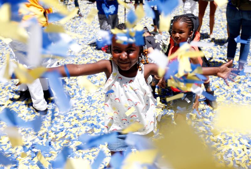 Golden State Warriors fans Zeynab Camara and her sister Maimouna Camara play in the confetti. Monica M. Davey / EPA