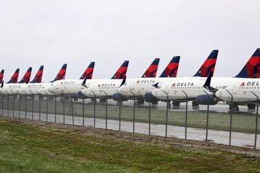 Delta Air Lines' planes sit idle at Kansas City International Airport in Kansas City, Missouri. US carriers, which are set to receive $60bn in relief from the government, reported an enormous drop in bookings amid the spread of the coronavirus.