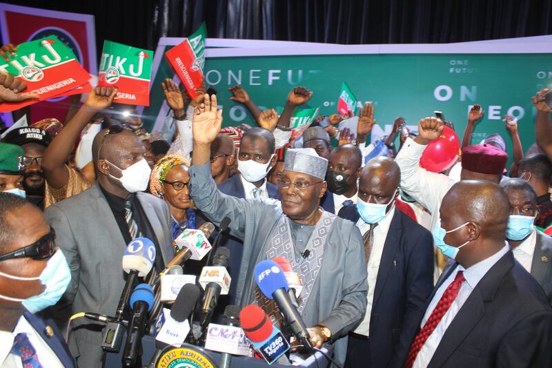 Atiku Abubakar, centre, waves to the crowd after declaring he will run next year.  AP