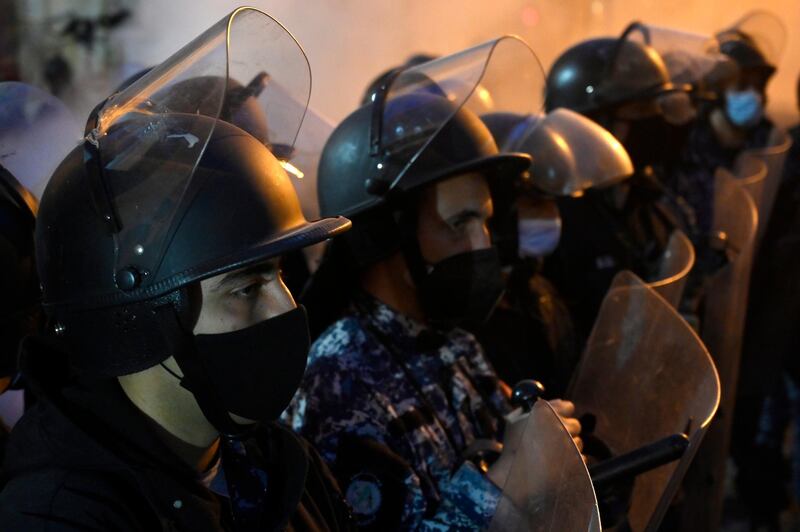 Riot police stands guard in front of Lebanese Central Bank during a rally against the power cuts, the high cost of living and the low purchasing power of the Lebanese pound, at Hamra street in Beirut. EPA