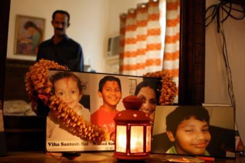 DUBAI, UNITED ARAB EMIRATES Ð May 22, 2011: Santosh Rai who lost two kids and his wife in the Air India plane crash last year at his home in Karama in Dubai. Every day he pray in front his family photograph. (Pawan Singh / The National) For News. Story by Preeti Kannan
