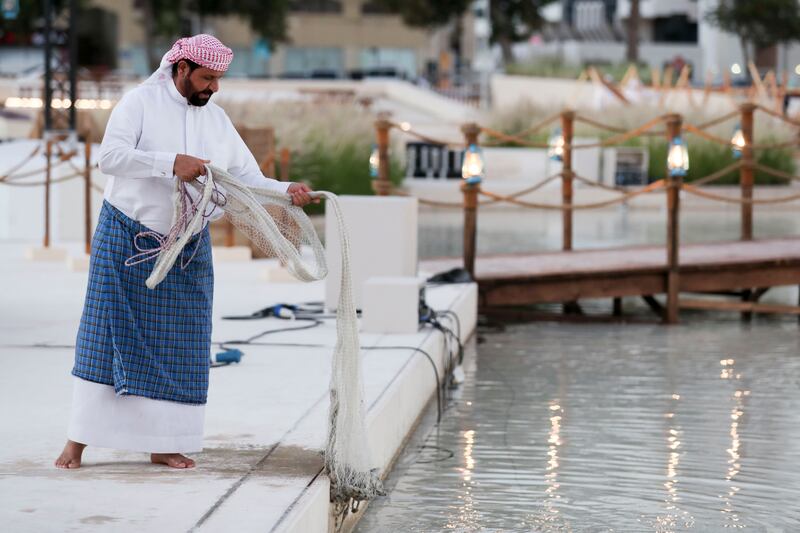 Emirati man showing the use of fishing nets from yesteryear.