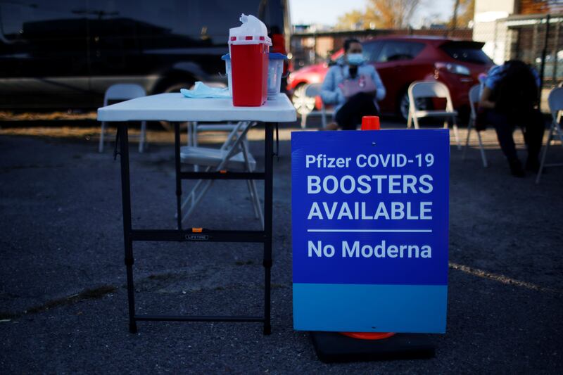 A sign informs potential patients that 'Pfizer Covid-19 Boosters Available, No Moderna' at a Covid vaccine clinic in Massachusetts. Reuters
