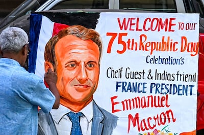 An artist gives finishing touches to a painting of French President Emmanuel Macron in Mumbai. AFP