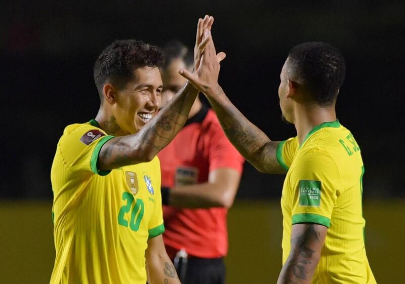 Brazil's Roberto Firmino celebrates with teammate Nelson Almeida after scoring their goal against Venezuela. Reuters