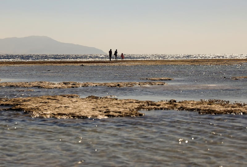 Tourists walk at the beach at low tide in the Red Sea resort of Sharm El-Sheikh, Egypt. Reuters