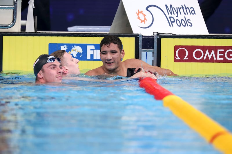 Florian Wellbrock celebrates his 1500m freestyle title and the world record.
