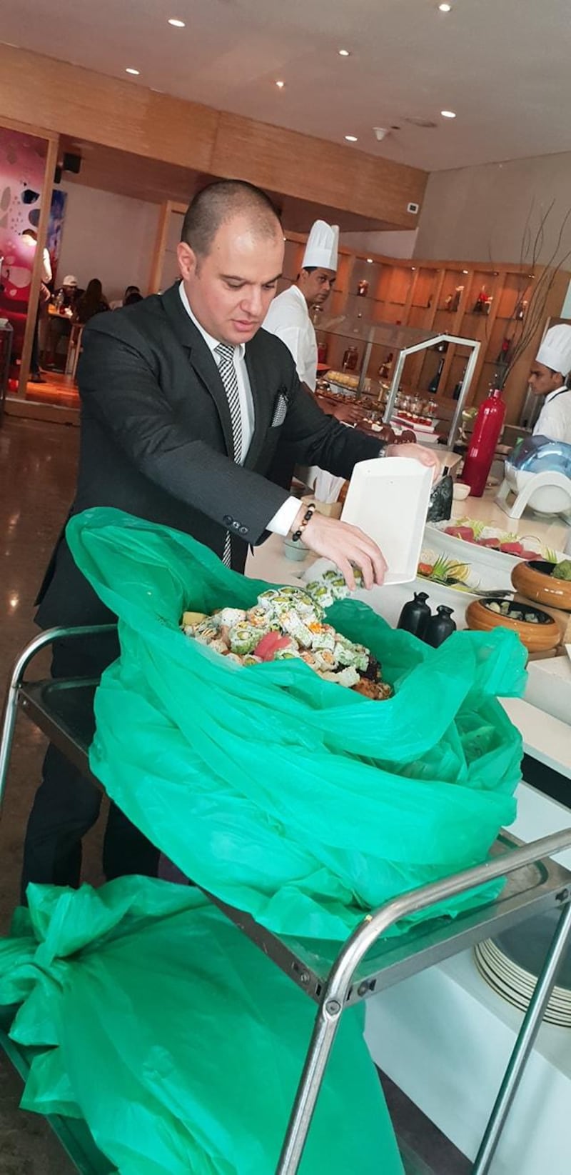 An employee at Fairmont Bab Al Bahr hotel in Abu Dhabi prepares the leftover food from last Friday's brunch. Courtesy Jamal Al Breiki