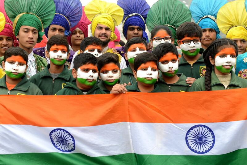 Indian school children pose with the national flag in Amritsar. Narinder Nanu / AFP