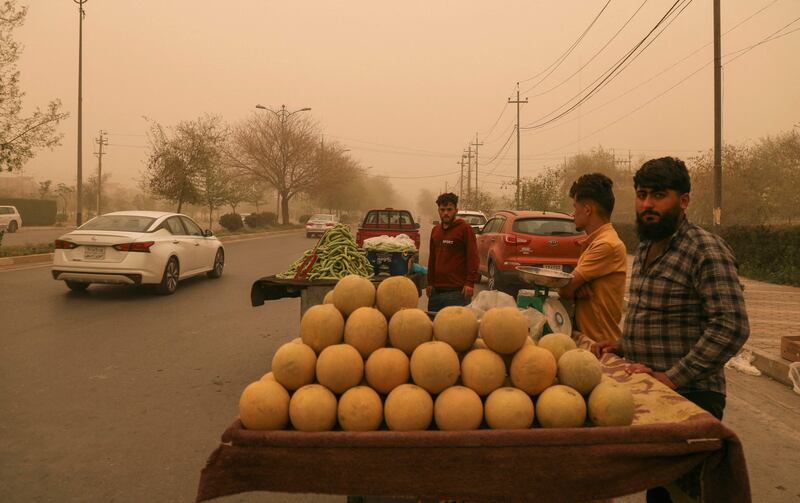 Street vendors defy the sandstorm to ply their trade at a roadside stall in Arbil, in northern Iraq.