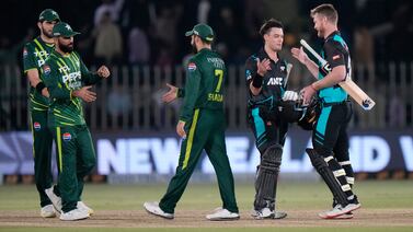 New Zealand's Mark Chapman, second right, celebrates with James Neesham after their win over Pakistan in the third T20 in Rawalpindi on Sunday. AP