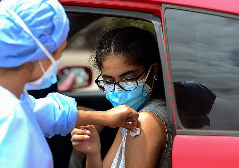 A teenager receives the first dose of the Pfizer/BioNTech Covid-19 vaccine in Tegucigalpa during a vaccination programme for teens aged 12 to 15. AFP