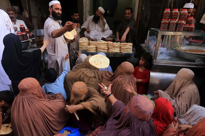 People receive free bread in Peshawar, Pakistan.  EPA