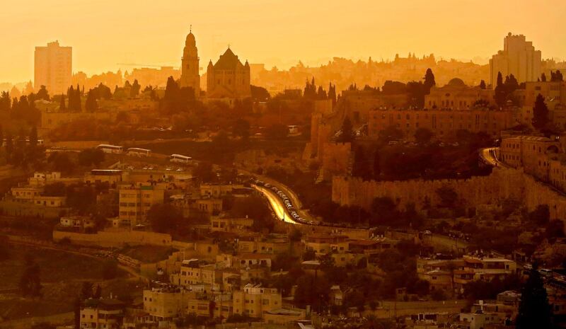 The sun sets during a sand haze in Jerusalem's Old City. Thomas Coex / AFP